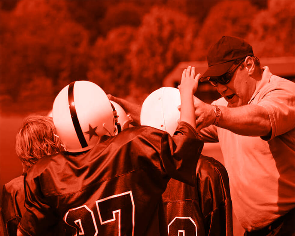 Coach with youth football players